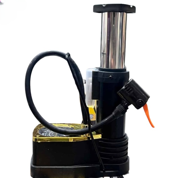 A black and yellow manual tire pump with an integrated gauge, shown next to its retail packaging box on a white background.